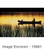 #15661 Picture Of Person And Dog Canoeing Through Wetlands Under An Orange Sunset