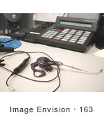 #163 Photograph Of A Headset And Phone On An Office Desk