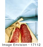 #17112 Picture Of Two Slabs Of Red Meat Near A Knife On A Wooden Cutting Board