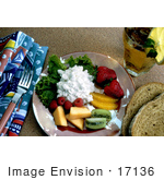 #17136 Picture Of Cottage Cheese Served On A Plate With Strawberries Oranges Kiwis Cantaloupe And Raspberries With Two Slices Of Wheat Bread And Iced Tea