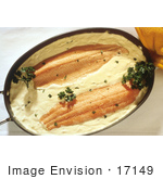 #17149 Picture Of Two Pieces Of Fish In Yellow Sauce And Garnished With Parsley In A Casserole Dish