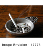 #17773 Photo Of A Smoking Cigarette And Cigarette Butts In An Ashtray