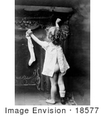 #18577 Photo of a Little Girl Child Showing Her Behind as She Reaches up to Hang a Stocking on Christmas by JVPD