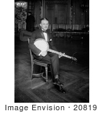 #20819 Stock Photography Of A Man Sitting In A Chair And Resting A Banjo On His Lap