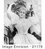 #21179 Stock Photography Of Lillian Russell In A Pretty Dress Sitting In A Carved Wooden Chair