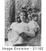 #21182 Stock Photography Of Lillian Russell Sitting In A Chair With Flowers Around Her Hair Holding A Hand Fan