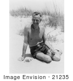 #21235 Stock Photography Of Eugene O’Neill The Playwright Wearing Swimming Shorts And Sitting In Warm Sand On A Beach