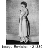 #21339 Stock Photography Of Mary Pickford Looking Back Over Her Shoulder And Holding Her Hands As If They Were A Gun