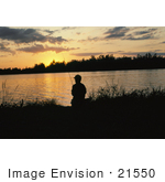 #21550 Sports Stock Photography Of Man Silhouetted While Fishing Against An Orange Sunset