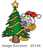 #23134 Clip Art Graphic Of A Flash Camera Cartoon Character Waving And Standing By A Decorated Christmas Tree