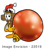 #23519 Clip Art Graphic Of A Wooden Cross Cartoon Character Wearing A Santa Hat Standing With A Christmas Bauble