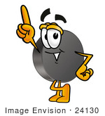 #24130 Clip Art Graphic Of An Ice Hockey Puck Cartoon Character Pointing Upwards