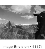 #41171 Stock Photo Of A Lone Man Standing On An Overhanging Rock Cliff At Glacier Point With A View Of Half Dome And The Valley Of Yosemite National Park California