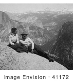 #41172 Stock Photo Of A Couple Relaxing On A Rock Cliff With A View Of The Cap Of Liberty Nevada Falls And The Sierras From Eagle Peak Yosemite National Park California