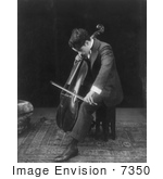 #7350 Black and White Stock Photograph of Charlie Chaplin Seated and Playing a Cello by JVPD