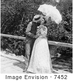 #7452 Stock Photo of a Man and Woman Kissing Under a Parasol by JVPD
