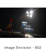 #802 Photography Of A Road Construction Flagger At Night In The Rain