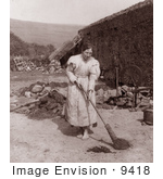 #9418 Picture Of A Woman Sweeping By A Spinning Wheel