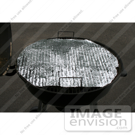 #10904 Picture of Foil With Holes Covering a Rusty BBQ Grill by Jamie Voetsch