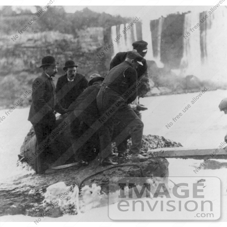 #13740 Picture of Men Pulling Annie E Taylor’s Barrel Out of the Water at Niagara by JVPD