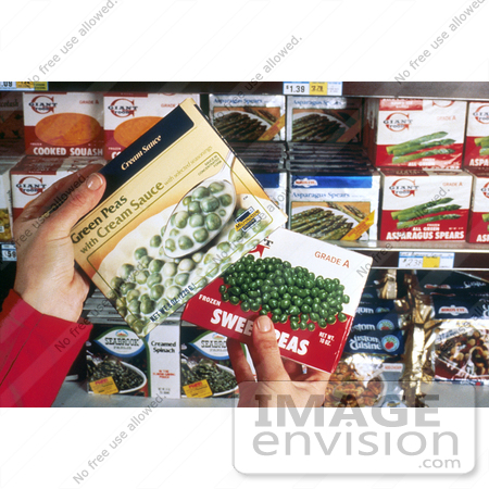 #17096 Picture of a Woman’s Hands Holding Two Boxes of Frozen Peas, Trying to Decide Whether or Not to Make a Healthy Decision by JVPD