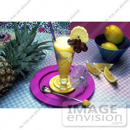 #17117 Picture of a Fruit Drink Beverage in a Tall Clear Glass on a Table With Pineapple and Lemons by JVPD