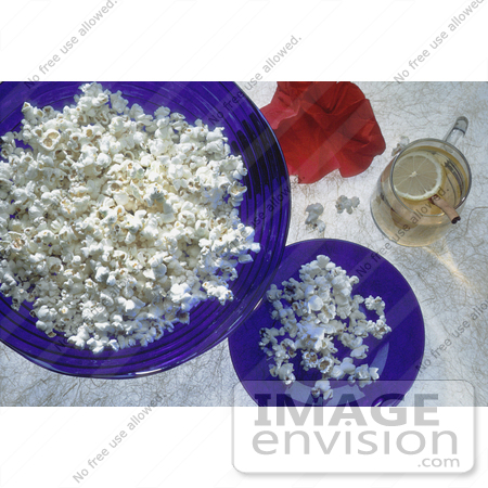 #17120 Picture of Plain White Popcorn in Blue Glass Bowls, Glass of Lemon Tea, Cinnamon Stick and a Red Poppy by JVPD