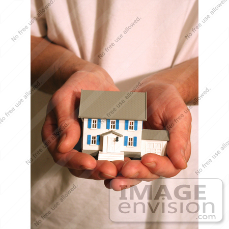 #178 Photo of a Man Holding a Model House in His Hands by Jamie Voetsch