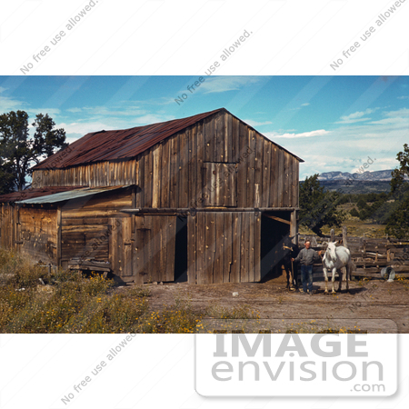 #17869 Photo of a Farmer With a Black Horse and a White Horse Outside a Wood Barn by JVPD