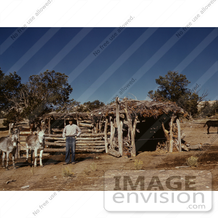 #17879 Photo of a Farmer With His Donkeys Near a Log Barn by JVPD