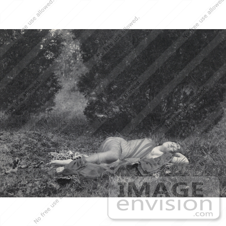 #18625 Photo of a Young Woman Lying on a Leopard Skin Outdoors, Wearing a Sheer Cloth by JVPD