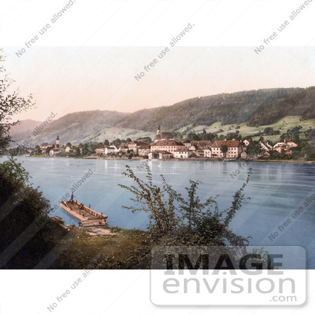#19489 Photo of a Man on a Dock Across From the Waterfront Village of Engelhartszell in Upper Austria by JVPD