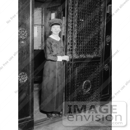 #20079 Stock Photography: Female Elevator Attendant Holding a Door Open at the Martha Washington Hotel by JVPD
