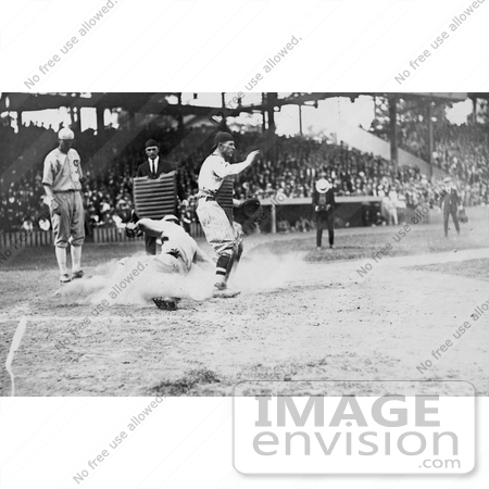 #21126 Stock Photography of an Umpire Waiting as a Runner Slides Onto Home Base by JVPD