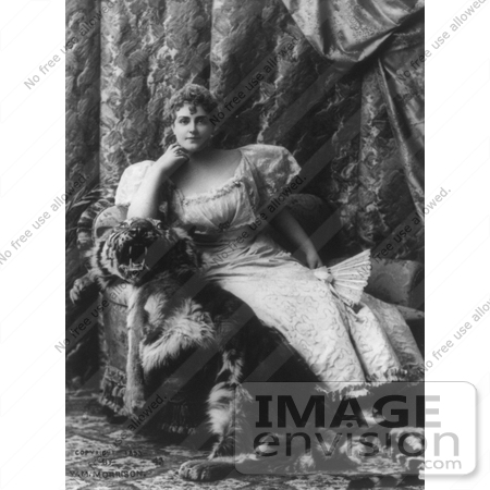 #21178 Stock Photography of Lillian Russell Holding a Hand Fan and Sitting on a Tiger Skin Over a Chair by JVPD