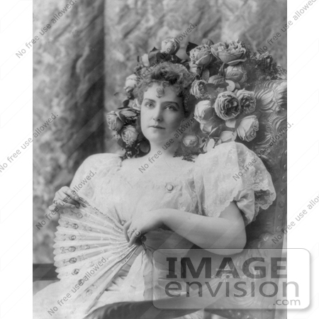 #21182 Stock Photography of Lillian Russell Sitting in a Chair With Flowers Around Her Hair, Holding a Hand Fan by JVPD