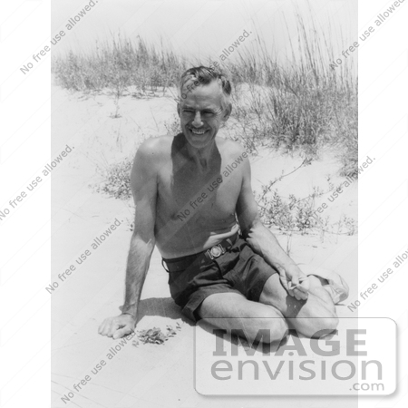 #21235 Stock Photography of Eugene O’Neill, the Playwright, Wearing Swimming Shorts and Sitting in Warm Sand on a Beach by JVPD