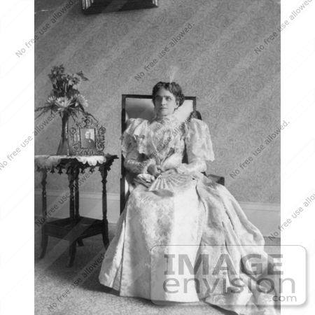 #21401 Stock Photography of First Lady Ida Saxton McKinley in a Gown, Sitting by a Vase of Flowers and Portrait on a Table by JVPD