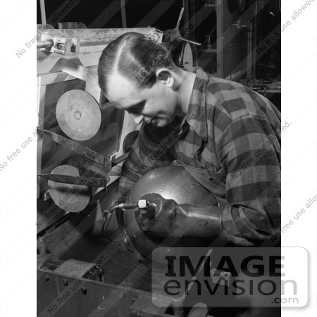 #21430 Historical Stock Photography of a Male Worker Inspecting an Aviation Oxygen Cylinder at a Factory, 1942 by JVPD