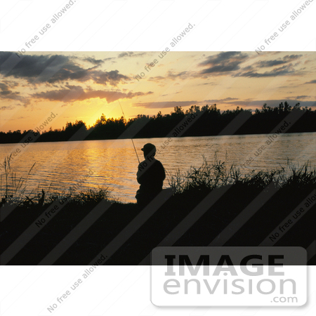 #21550 Sports Stock Photography of Man Silhouetted While Fishing Against an Orange Sunset by JVPD
