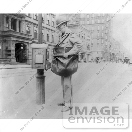 #21603 Stock Photography of a New York City Mail Man Checking Outgoing Mail at a Post Box, Carrying a Mail Bag by JVPD