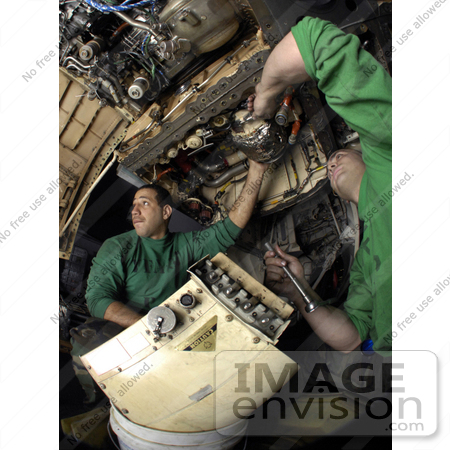 #21697 Stock Photography of United States Navy Men Removing an Electrical Generator From a F/A-18C Hornet by JVPD