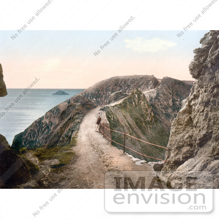 #21797 Historical Stock Photography of a Man Leaning Against the Railing on La Coupee Isthmus in Sark, England by JVPD