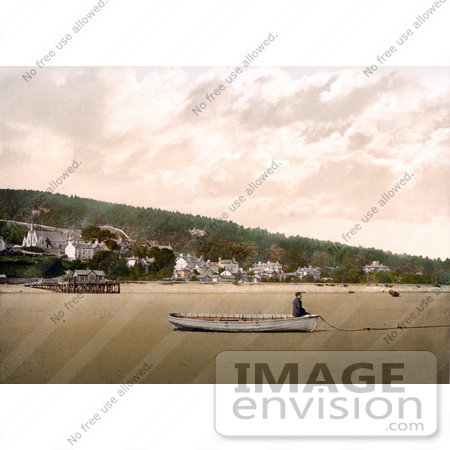 #21884 Historical Stock Photography of a Man Sitting in a Boat on the Sand at Low Tide in Grange-over-Sands, Cumbria, England by JVPD