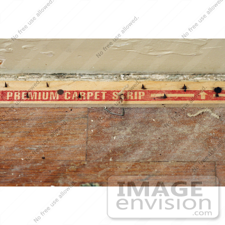Stock Photography Of Nails In A Carpet Tack Strip On A Dusty Wood