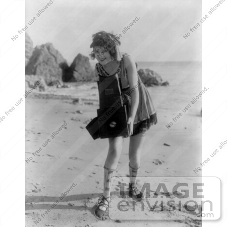 #26769 Stock Photography of a Female Actress, Myrtle Lind, Holding a Camera on a Beach in 1919 by JVPD