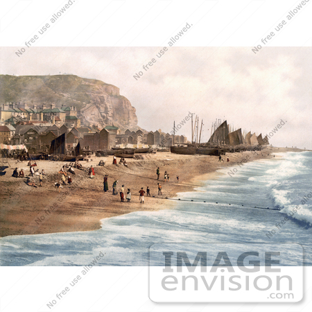 #26787 Stock Photography of Blue Ocean Waves Rolling Towards Ships, Net Shops and People on the Beach at the Fish Market on the East Cliff in Hastings East Sussex England UK by JVPD