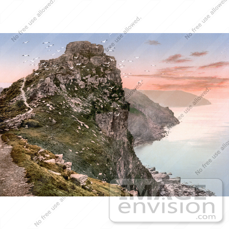 #26824 Stock Photography of Seagulls Flying Around Castle Rock Over The Bay At Sunset In The Valley Of Rocks Exmoor Lynton And Lynmouth Devon England UK by JVPD