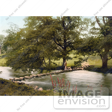 #26860 Stock Photography of a Man in a Hat, Using a Cane While Crossing a Stream on Stepping Stones in the Lake District in Ambleside Cumbria England UK by JVPD