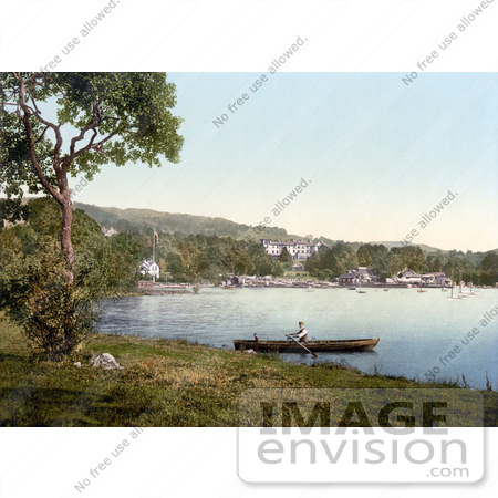 #26865 Stock Photography of a Man Rowing a Boat by the Docks and Belsfield Hotel in Bowness on Lake Windermere Lake District Cumbria England UK by JVPD